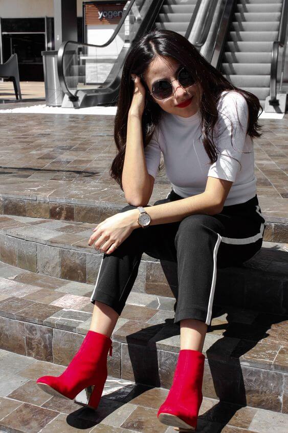 Outfit blanco y negro con botines con tacón en rojo.